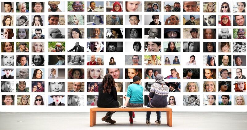 A group of people looking at photos of people